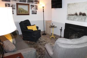 a living room with a couch and chairs and a fireplace at Oak Square 210 in Gatlinburg