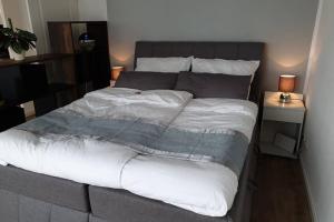 a bedroom with a large bed with white sheets at Deine Auszeit in Kiel