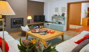 a living room with a couch and a coffee table at Casa Limonina in Louriçal