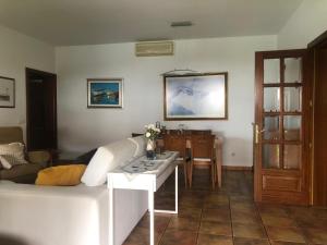 a living room with a white couch and a table at Villa Altamosa in Yaiza
