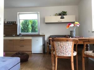 a kitchen and dining room with a table and a window at GRÜNER HAUS in Gampern