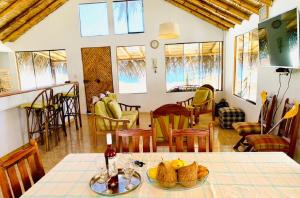 uma sala com uma mesa com uma tigela de fruta em Posada del Mar Vichayito em Los Órganos
