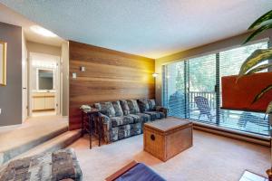 a living room with a couch and a large window at The Gables 39 in Whistler
