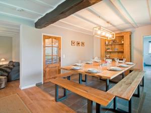 a dining room with a wooden table and benches at Holiday Home between Spa and Eifel Nature Park in Xhoffraix