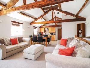 sala de estar con techos de madera y comedor en Carleton Mill Cottage, en Carlisle