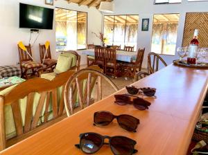 a table with sunglasses sitting on top of it at Posada del Mar Vichayito in Los Órganos