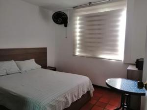 Postel nebo postele na pokoji v ubytování Hotel 42 Avenida