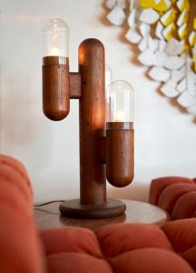 a wooden candle holder with candles on a table at Hotel Magdalena in Austin