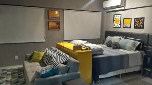 a bedroom with a bed and a chair and a couch at Time Home Service 1411 in Maceió +11 photos