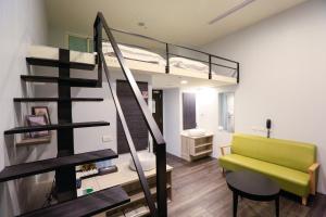 a room with a loft bed and a green bench at Place‧X Hotel in Taipei