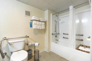 a bathroom with a white toilet and a shower at Days Inn by Wyndham Kuttawa/Eddyville in Kuttawa