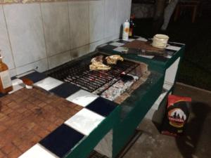 a kitchen with a grill in a room at Amigos Hostel Cozumel in Cozumel