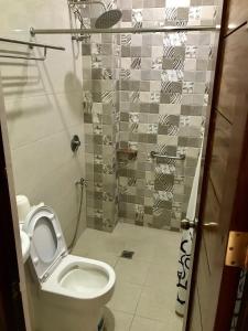a bathroom with a toilet and a shower at Lucena Fresh Air Hotel in Lucena