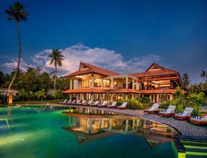 a resort with a pool in front of a building at Niraamaya Wellness Retreats Backwaters And Beyond in Kumarakom