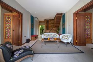 a living room with two chairs and a table at Menzel Ubud in Ubud