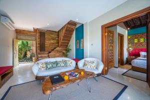 a living room with a couch and a table at Menzel Ubud in Ubud