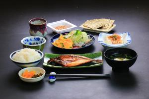 a table with plates of food and bowls of food at Banshoukaku in Tsushima +9 photos