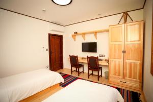a bedroom with two beds and a desk at Родопчани Старцево in Starzewo