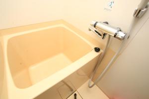 a bathroom with a sink in a room at Banshoukaku in Tsushima