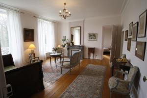 a living room with a couch and a fireplace at Château de Penfrat in Gouesnach