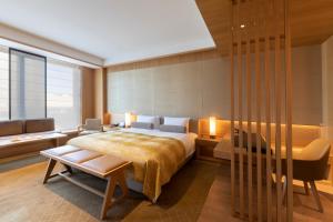 a bedroom with a bed and a desk and a chair at The Okura Heritage Tokyo in Tokyo