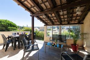 un patio con tavolo e sedie sul balcone. di Design Industriel avec Terrasse Privative a Gignac-la-Nerthe