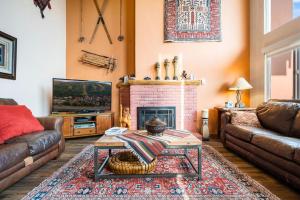 a living room with a couch and a fireplace at Vantage Point #408 Condo in Vail