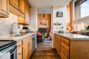 a kitchen with a sink and a counter top at Vantage Point #408 Condo in Vail +23 photos