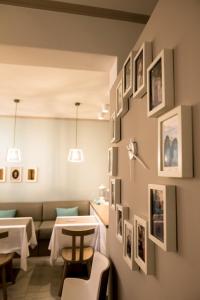 a dining room with pictures on the wall at Kokona in Symi