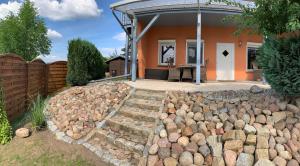 a home with a rock garden in front of a house at FerienHaus Zur Sonne, Zislow in Zislow