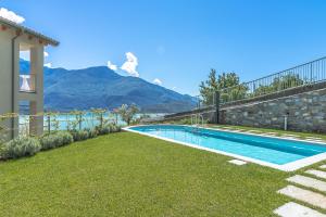 a swimming pool with a mountain in the background at Apartment Veronica - Domaso in Domaso