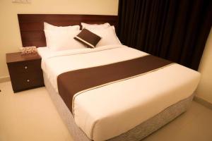 a bedroom with a large bed with a book on it at Hotel Golden Hill in Cox's Bazar