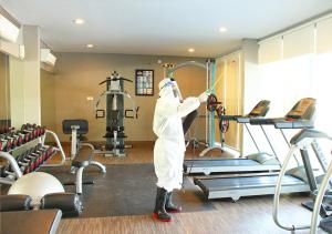 a person in a white suit in a gym at Gammara Hotel Makassar in Makassar