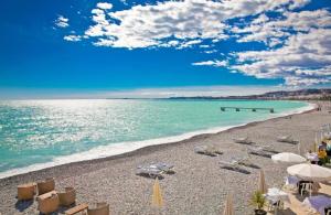 a beach with a lot of boats on it at Logis Hôtel Villa Victorine in Nice