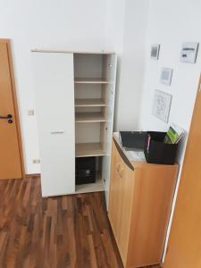 a closet with an open door and a book shelf at Zur Alten Oberförsterei in Benneckenstein