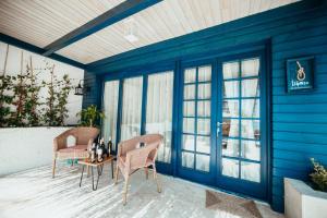 a patio with two chairs and a table with bottles on it at Büyükada Loc'ada in Adalar