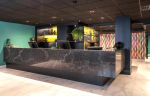 a lobby with a counter with chairs and a bar at Thon Hotel Bristol, Bergen in Bergen