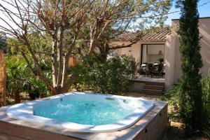 a jacuzzi tub in the yard of a house at Domaine Santa Giulia Palace in Porto-Vecchio