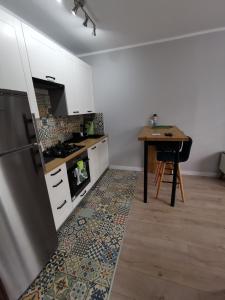 a kitchen with a table and a refrigerator at Stare Miasto in Głogów