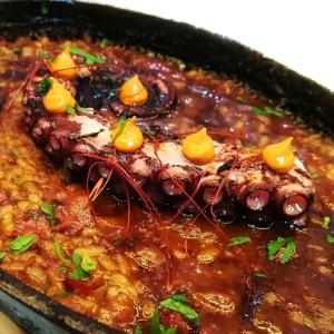 a dish of food with meat and beans at Axel Hotel San Sebastián - Adults Only in Donostia-San Sebastián