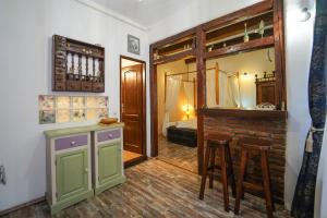 a room with a bar and some chairs and a mirror at Kron Studio Kalista in Braşov