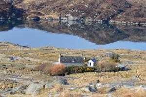 a small house in a field with two reservoirs at George's House - 1 Leacklee in Manish