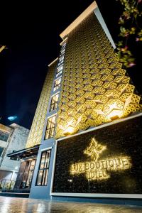 a large building with a luxury boutique hotel at night at Lux Boutique Hotel in Nonthaburi