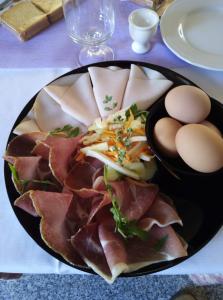 a plate of meat and eggs on a table at Hotel Leon D'Oro in Castelfrentano