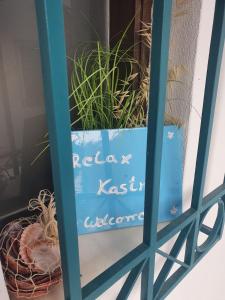 a sign on a window with some plants in it at Relax in Kastro in Kástro Tornéze