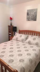 a bedroom with a bed with a white comforter at Comfy Home in Aberdeen
