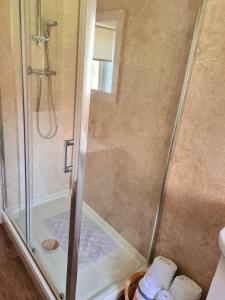 a shower with a glass door in a bathroom at Churchview in Townhill