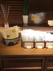 a shelf with containers of food on a table at Galois Hotel Shinokubo in Tokyo