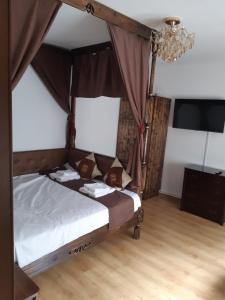 a bedroom with a bed with a canopy at Casa Silvia in Constanţa