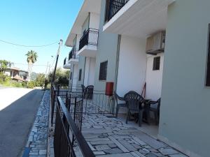 balkon domu z krzesłami i ogrodzeniem w obiekcie Athanasios Tsoumas Apartments w mieście Kastrosikia
